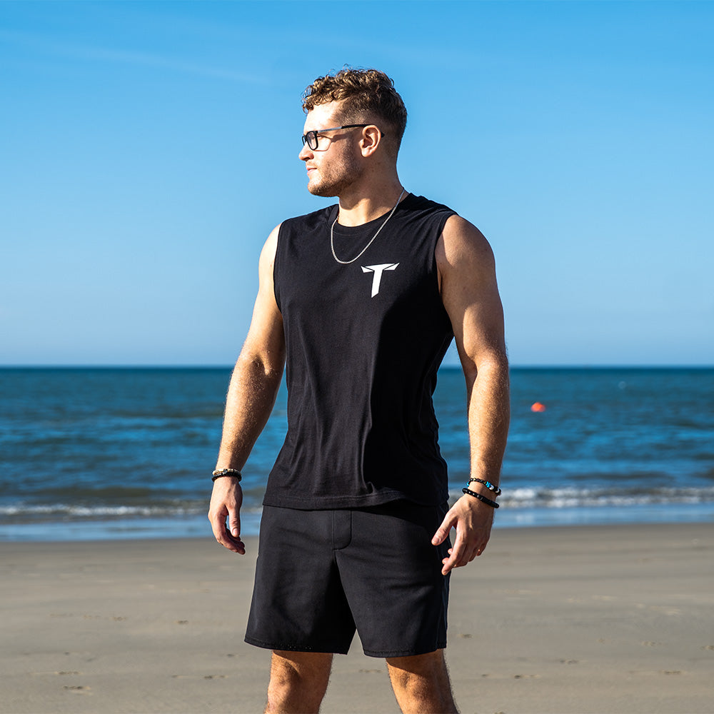 Teminite Logo Tank Top – Black, worn on the beach, front view